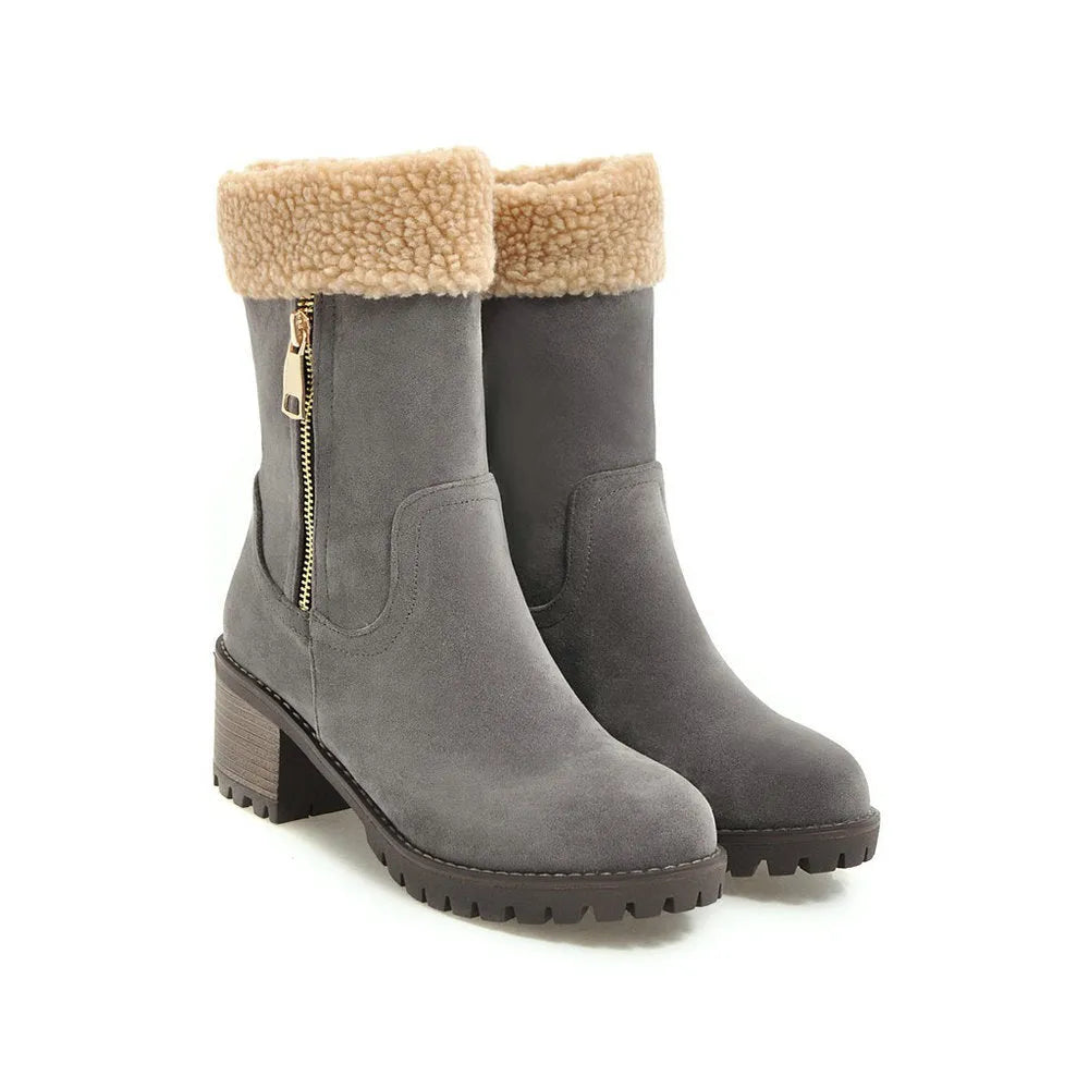 A pair of snow boots in black, grey, green, or orange with a rubber sole and plush lining.