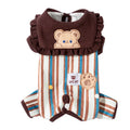 Small brown dog wearing a blue and brown striped onesie with ruffled collar and bear patch