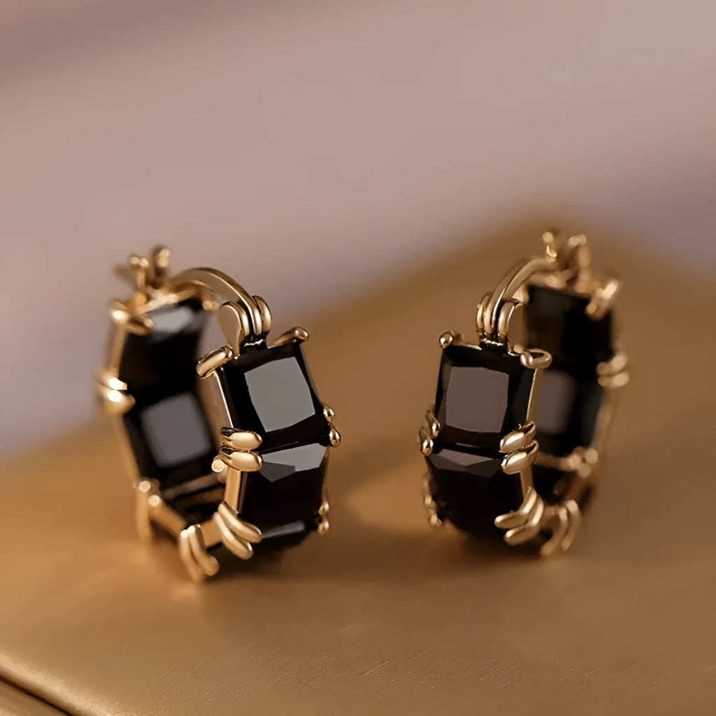 Gold geometric U-shaped women's earrings with a round black crystal zirconium stone.