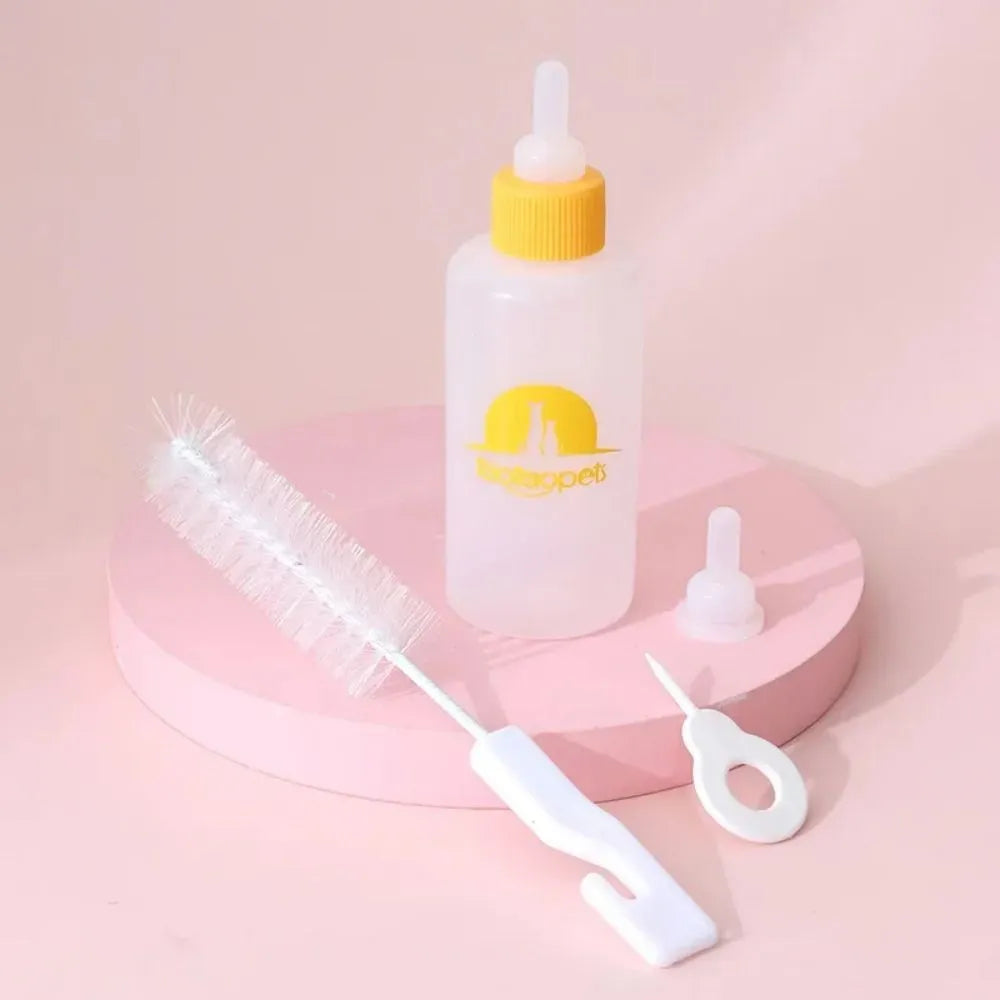 Set of four coloured pet milk bottles and a cleaning brush for feeding small animals