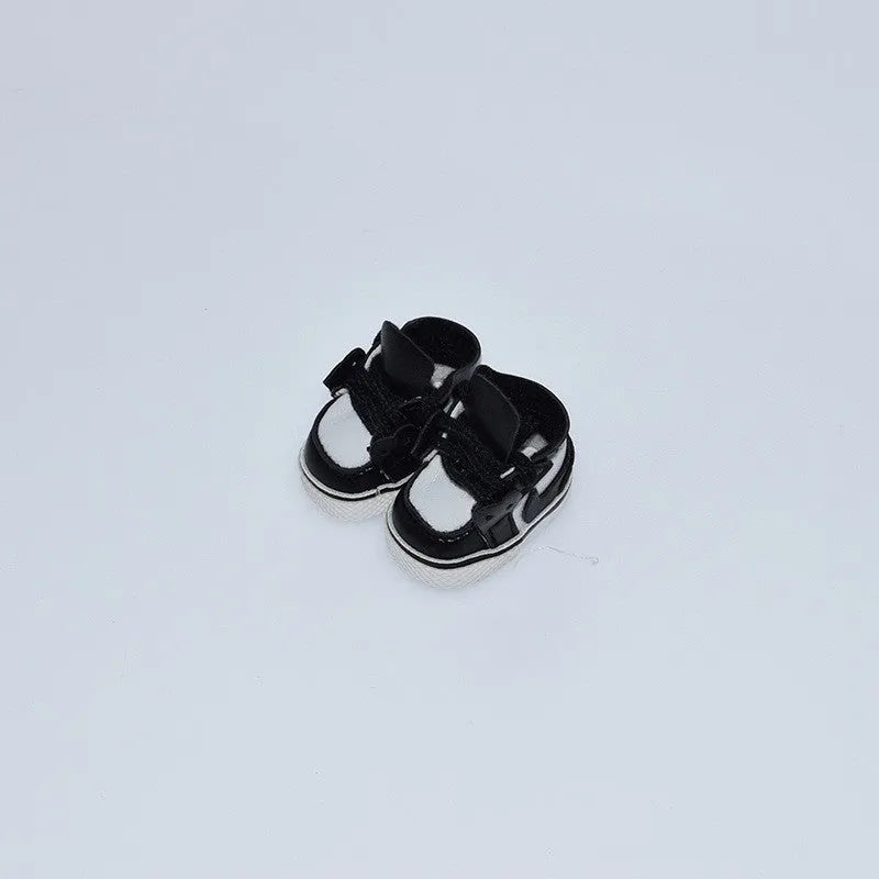 A pair of 17cm scale PU doll shoes in a selected colour and style, such as black leather shoes or brown boots.