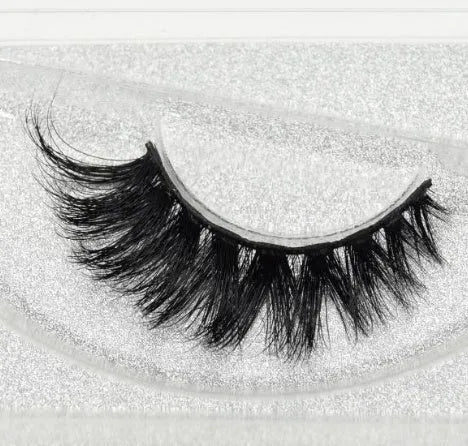 Pair of faux mink eyelashes with long tail and cotton stem against white background