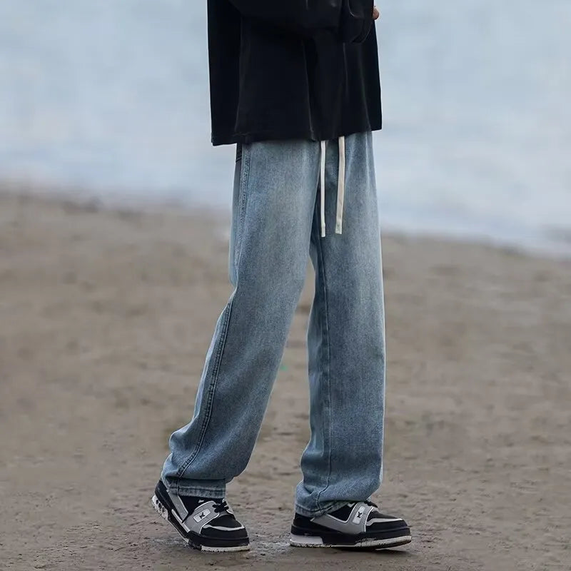 Men's loose fit straight-leg jeans in black or blue with drawstring waist closure