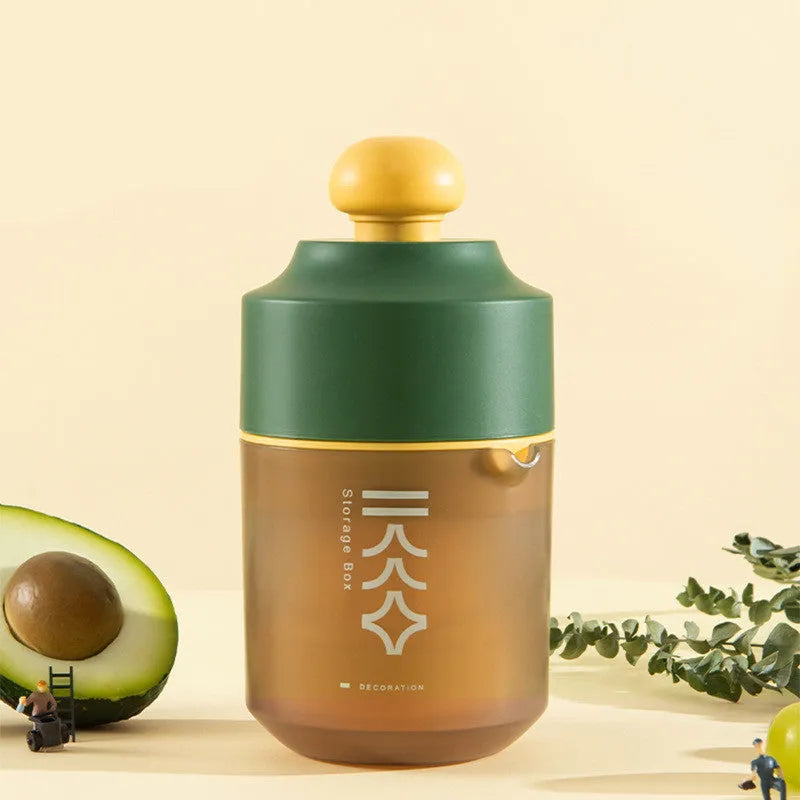 Green manual citrus juicer with lid and plunger, shown with lemons.