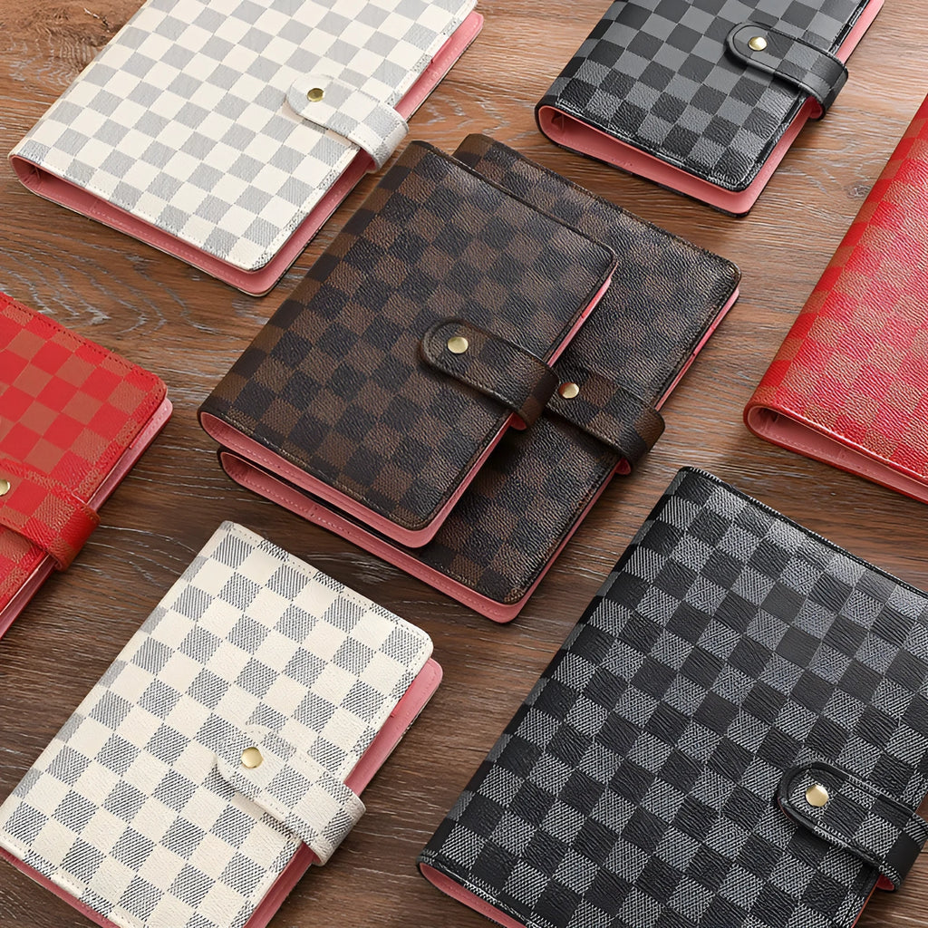 Loose-leaf notebook with imitation leather cover in A5 size, red colour, open showing ring binding and blank pages
