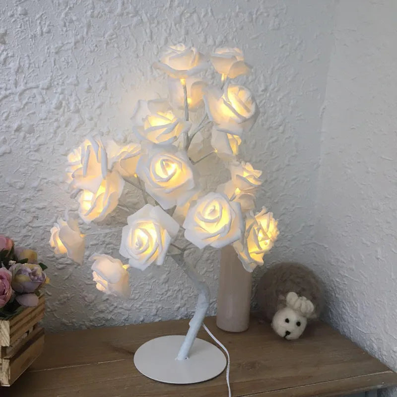 White and red rose flower LED table lamp with bonsai tree lights on a table.