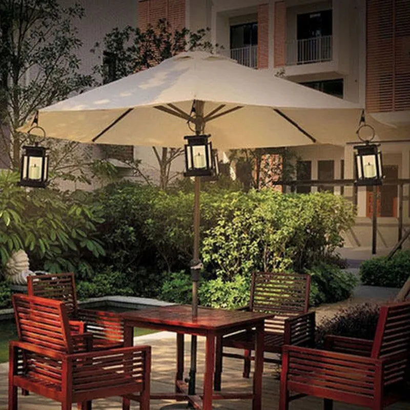 Solar LED candle light with black plastic shade, monocrystalline panel, and warm white illumination on garden path