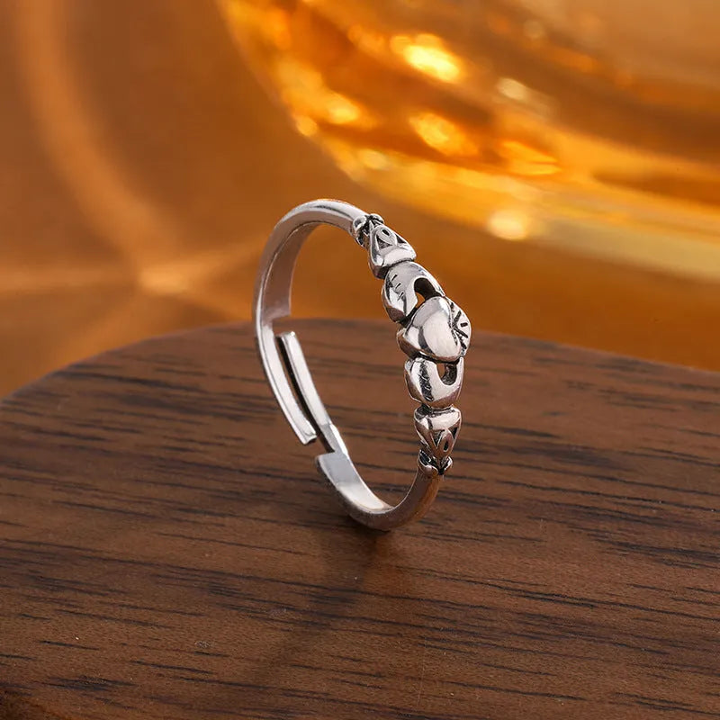 Open ring for women in retro silver with a detailed heart shape design on a copper base.