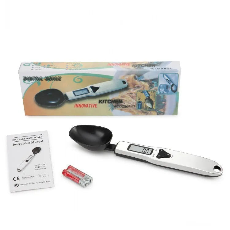 Black digital measuring spoon with LCD display showing weight measurement for kitchen use