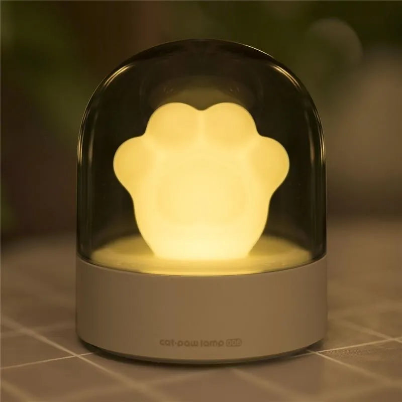 Grey cat paw shaped USB rechargeable night light with music box function on wooden desk