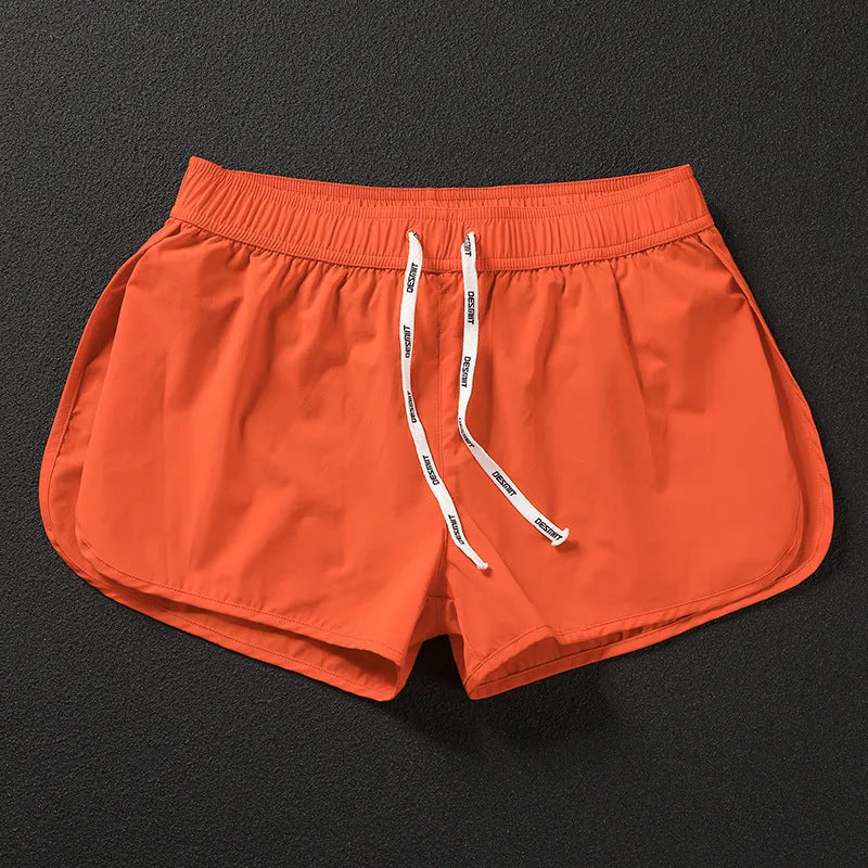 Men's loose fit elastic waist shorts in orange, green, or black for beach and surfing