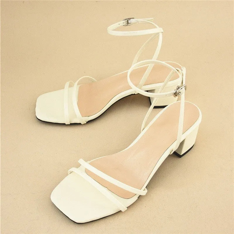 Beige women's chunky heel sandals with a square toe and ankle strap on a rubber sole.