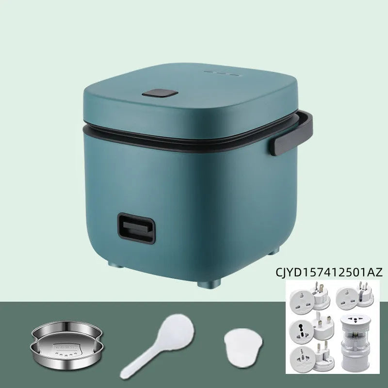 Green 1.2L mini rice cooker with metal body, steaming plate, rice spoon and measuring cup on countertop
