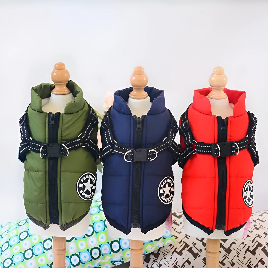 Waterproof dog coat with harness in red, navy blue, and army green on a winter background