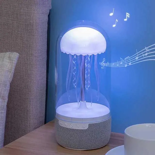 White compact 3-in-1 Bluetooth speaker jellyfish lamp with LED colour lights on a desk