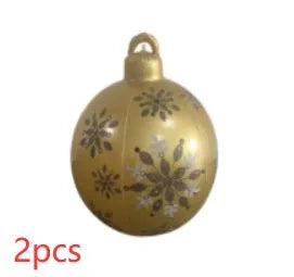 Large red and white striped inflatable Christmas ball ornament hanging on an outdoor tree