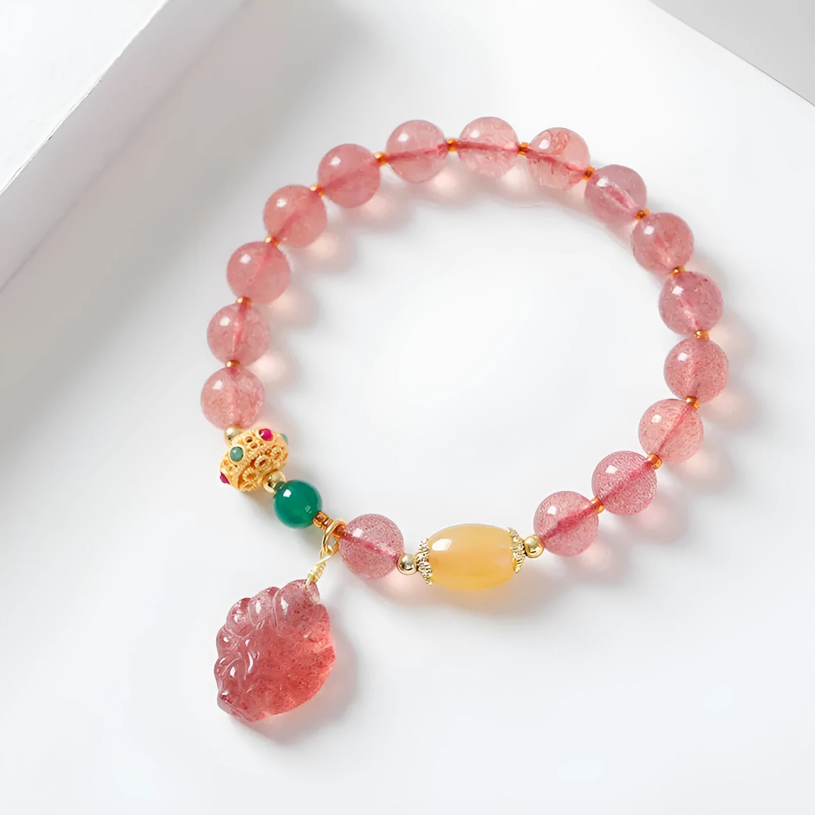 Women's Nine Tail Fox design bracelet with polished strawberry quartz crystal beads.