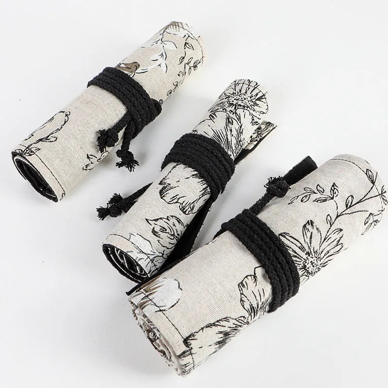 Black peony floral print canvas pencil roll bag unrolled to show 24 or 72 holes for pens.