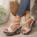 Women's cream white thick-soled ankle-strap buckle sandals with cloth upper and rubber sole.