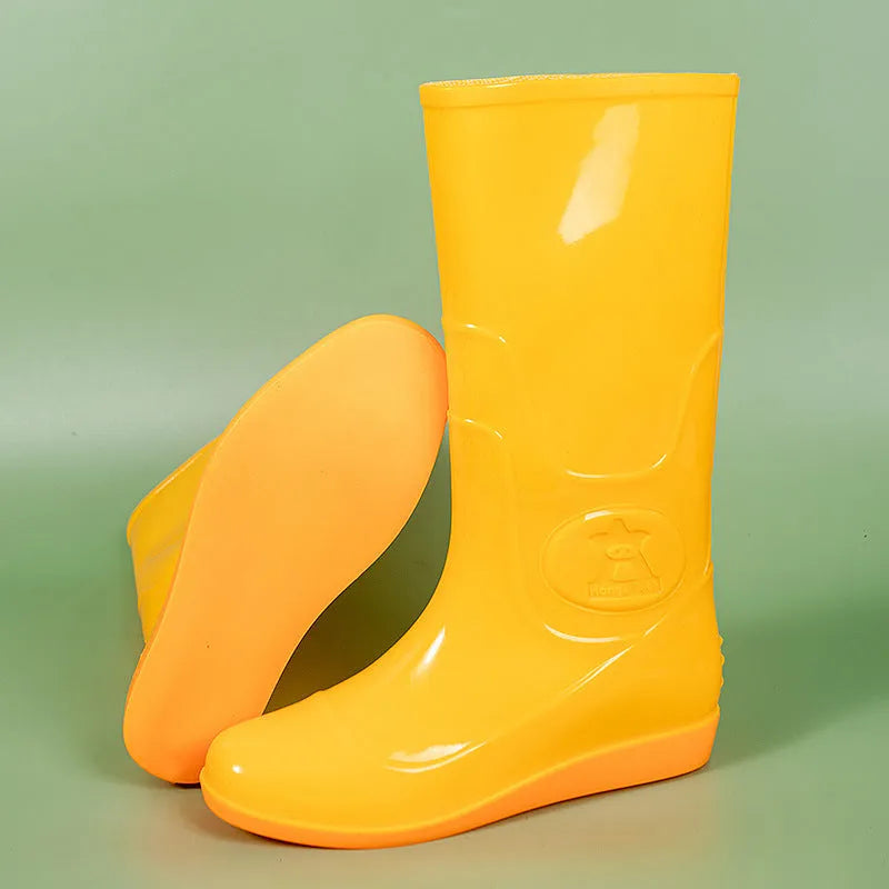 White and yellow plastic washable rain boots with high-tube design and flat heels for labour protection