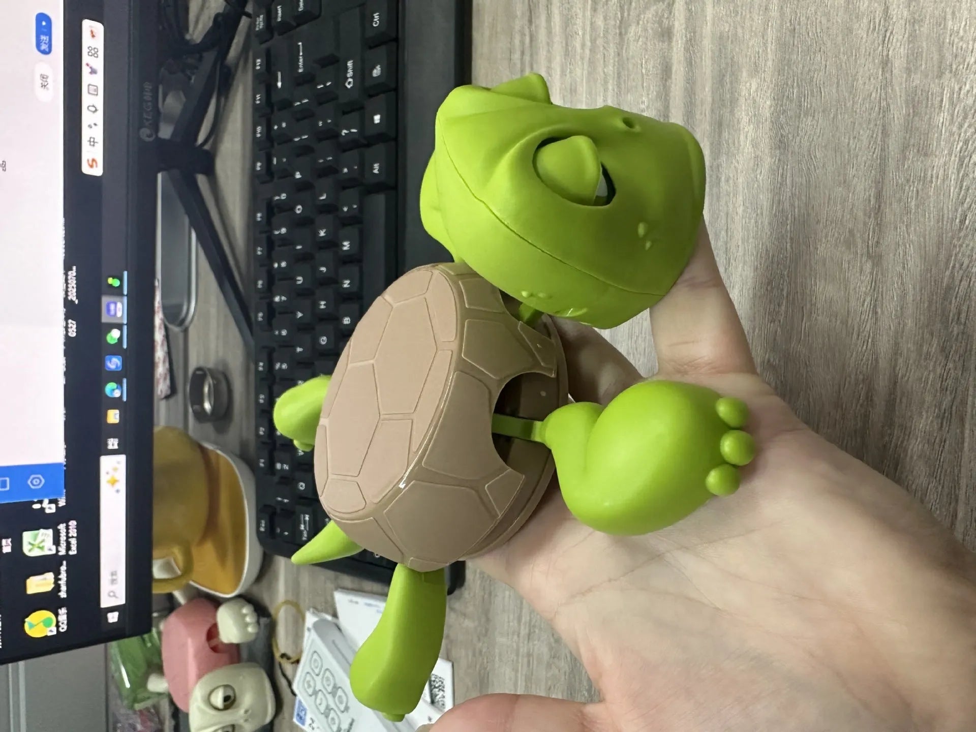 Creative turtle-shaped ABS plastic coaster in light green colour on a table