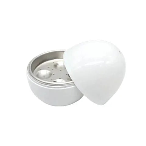 White microwave egg cooker with capacity for 4 eggs on kitchen counter