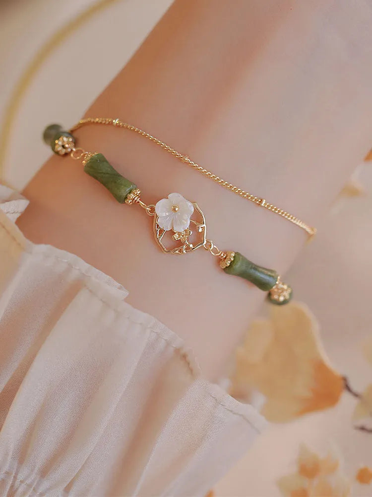 Natural olivine bracelet with Chinese double layer design featuring twin Bells of Ireland elements