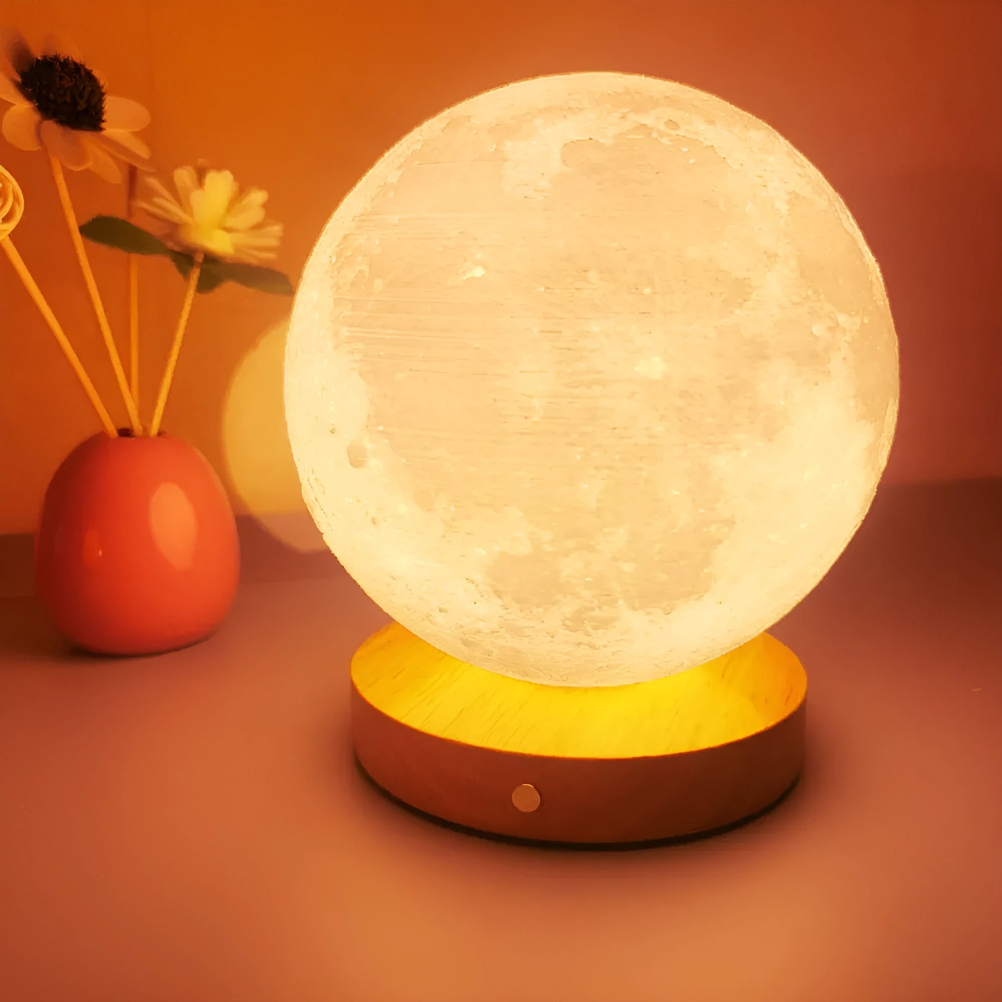 Rotating three-colour moon night light on a wooden base, showing 12cm, 15cm, and 18cm size options.
