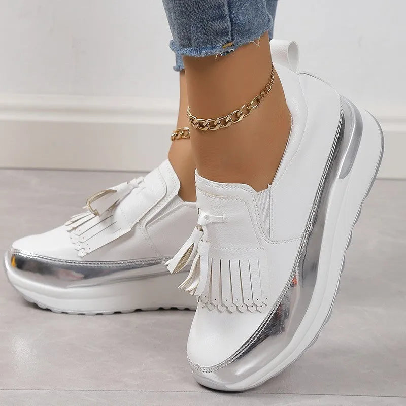 Women's black platform casual shoes with a tassel and a thick wedge heel.