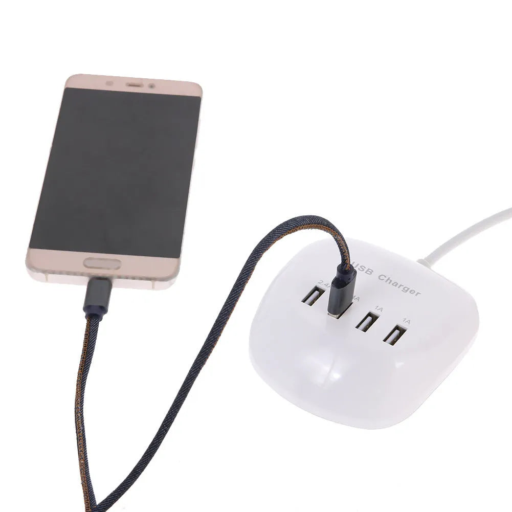 White dual USB wall charger with EU plug style next to smartphone and tablet