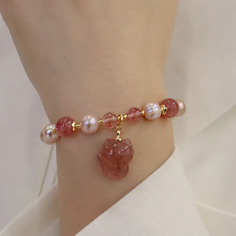 Light pink freshwater pearl bracelet for women with a dangling silver fox charm.