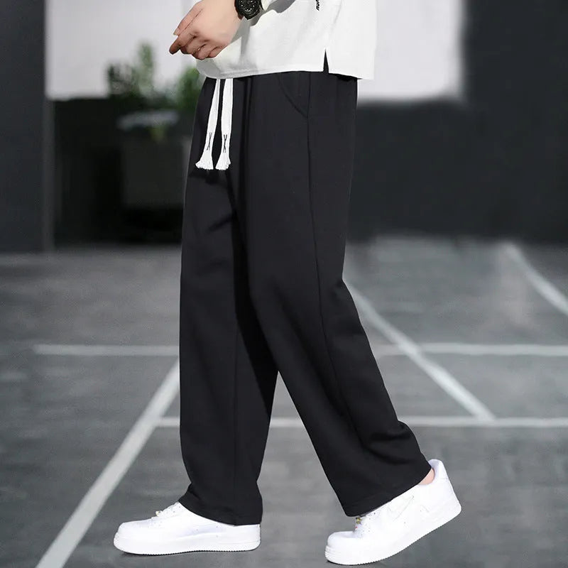 Casual grey men's sports trousers with multiple pockets and a high-waist design.