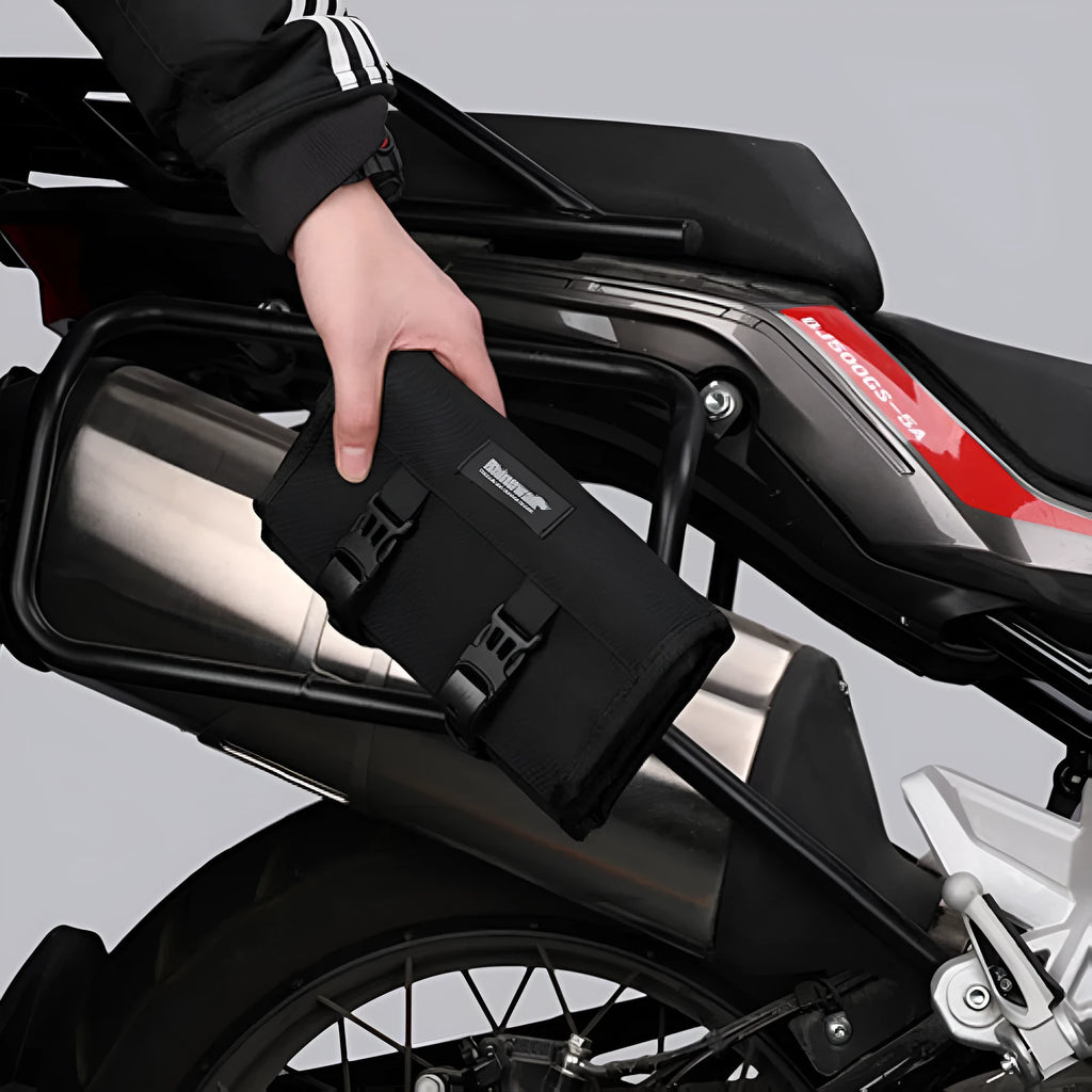 Motorcycle repair tool roll laid flat in black polyester with elastic straps and mesh zipper pocket