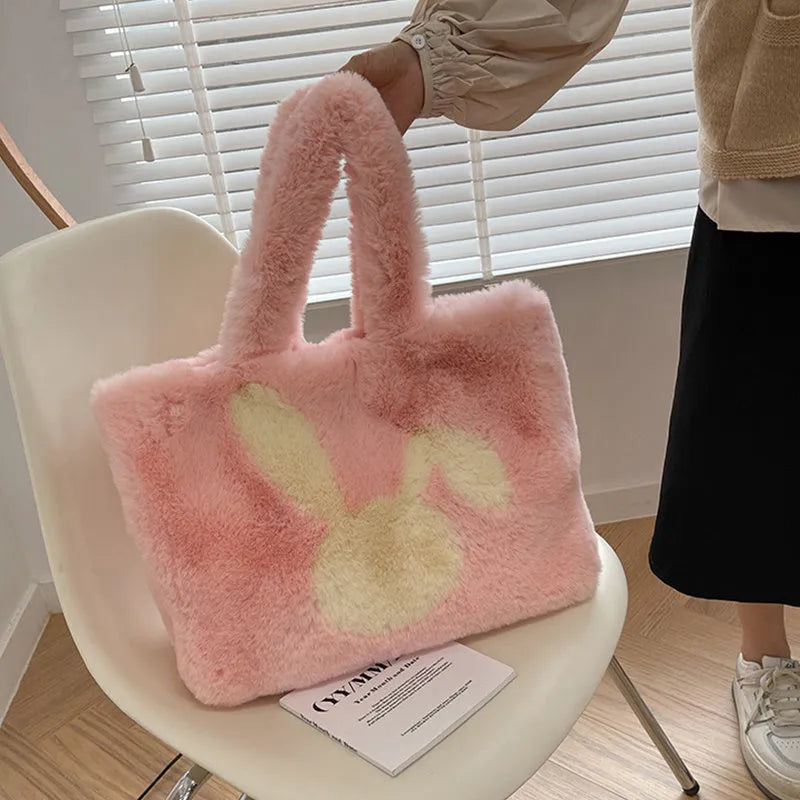 Soft beige plush tote bag with cartoon rabbit ears on the front, shown as a large capacity shoulder bag.