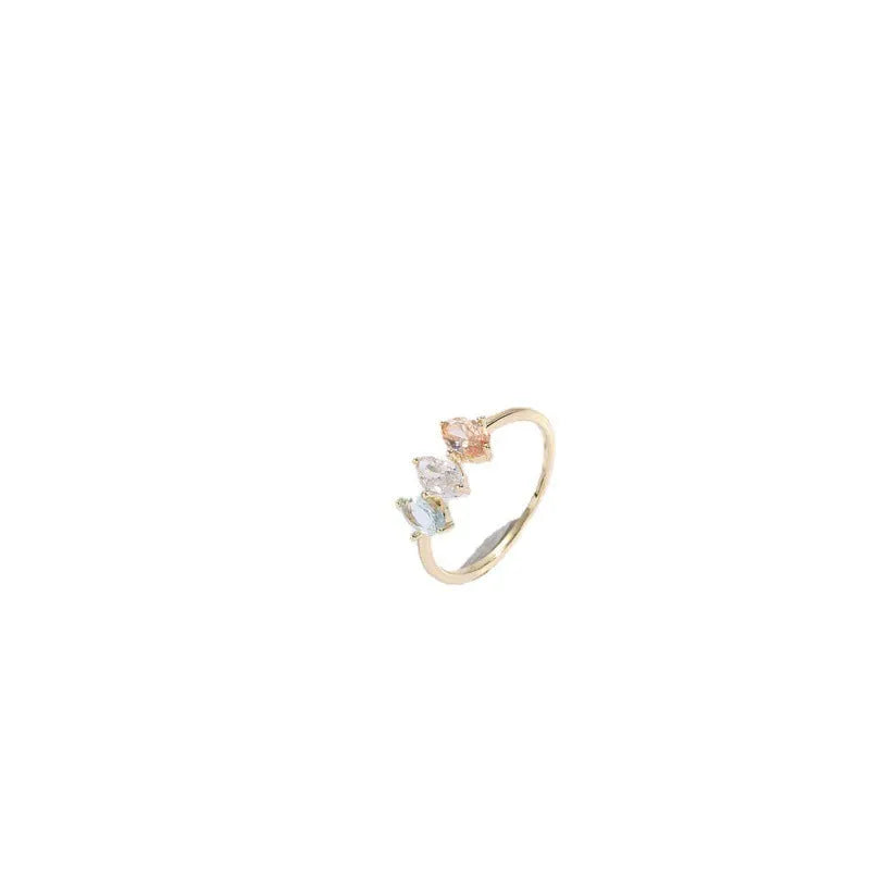 Geometric gold-colour women's ring with a triangular horse eye tricolour zircon stone.