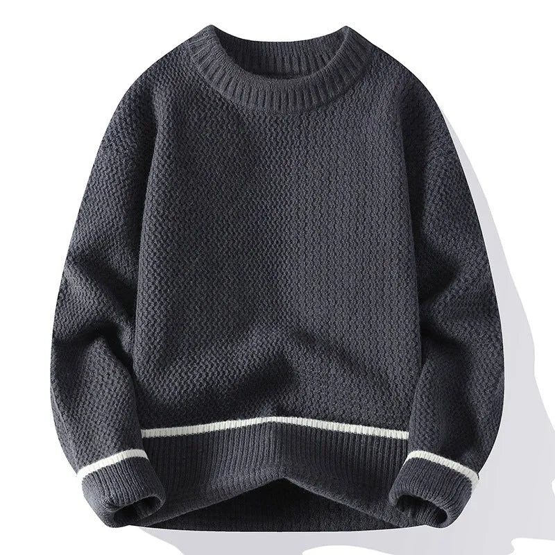 Man wearing a loose-fit grey casual pullover sweater with a round neck and long sleeves.