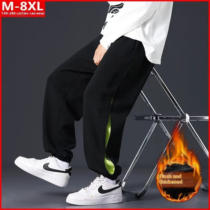 Men's loose fit cotton pants with elasticated ankle bands in grey green colour, showing collage stitching detail.