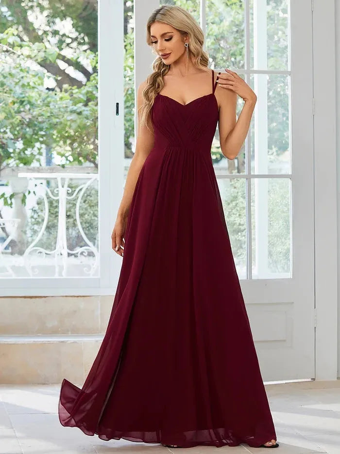 Women's sleeveless sling banquet dress with A-line long pleated skirt in solid colour polyester, front view