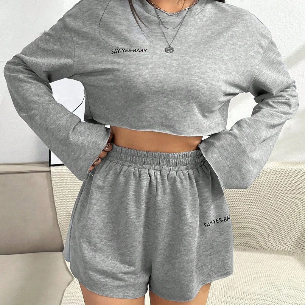 Grey women's long sleeve t-shirt and matching shorts loungewear set laid flat.