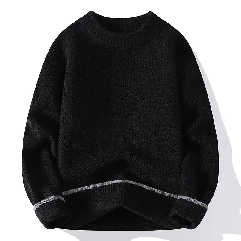 Man wearing a loose-fit grey casual pullover sweater with a round neck and long sleeves.