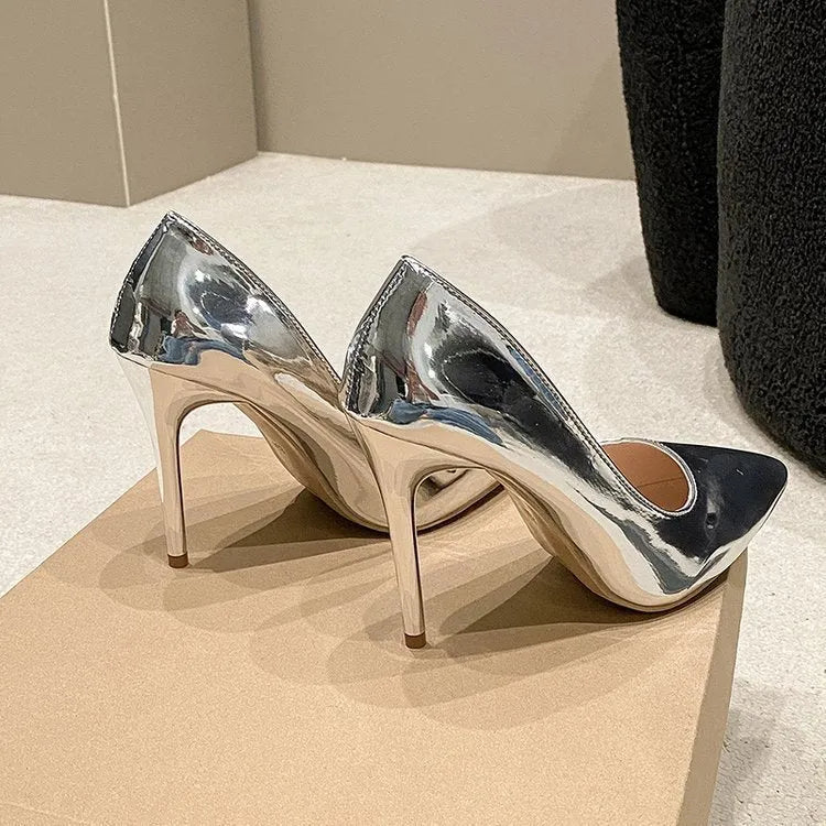 Women's gold metallic pointed toe stiletto heel slip-on pumps on a white background