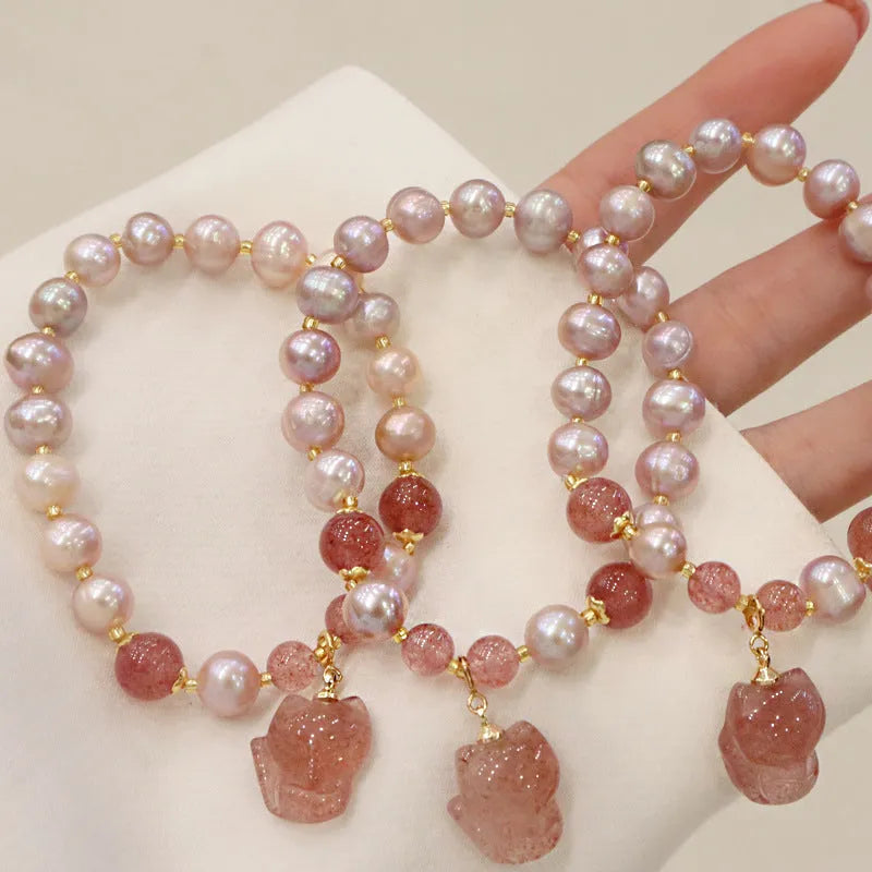 Light pink freshwater pearl bracelet for women with a dangling silver fox charm.