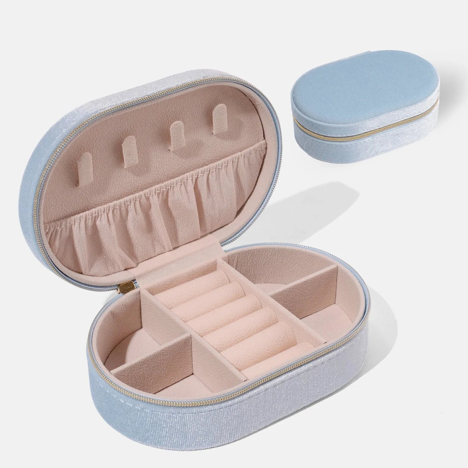 Oval velvet jewellery storage box in multiple colours with flannel lining, showing compact 15x10x5 cm size.