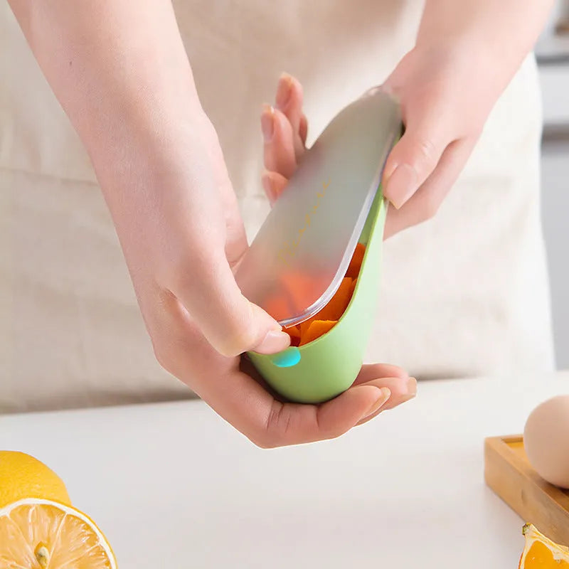 Dark green kitchen peeler with storage tube showing stainless steel blade and hanging hole on handle