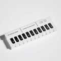 Black and white plastic piano temporary parking sign for car dashboard.