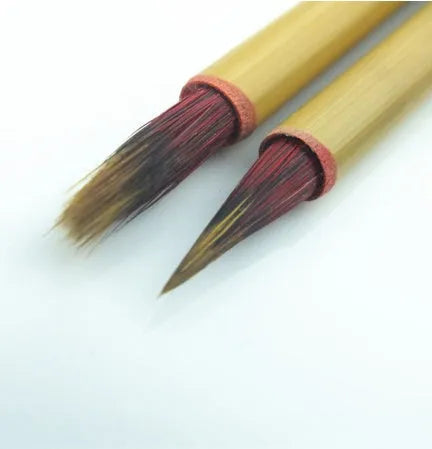 Small red Chinese writing brush with wooden penholder for calligraphy