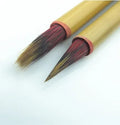 Small red Chinese writing brush with wooden penholder for calligraphy