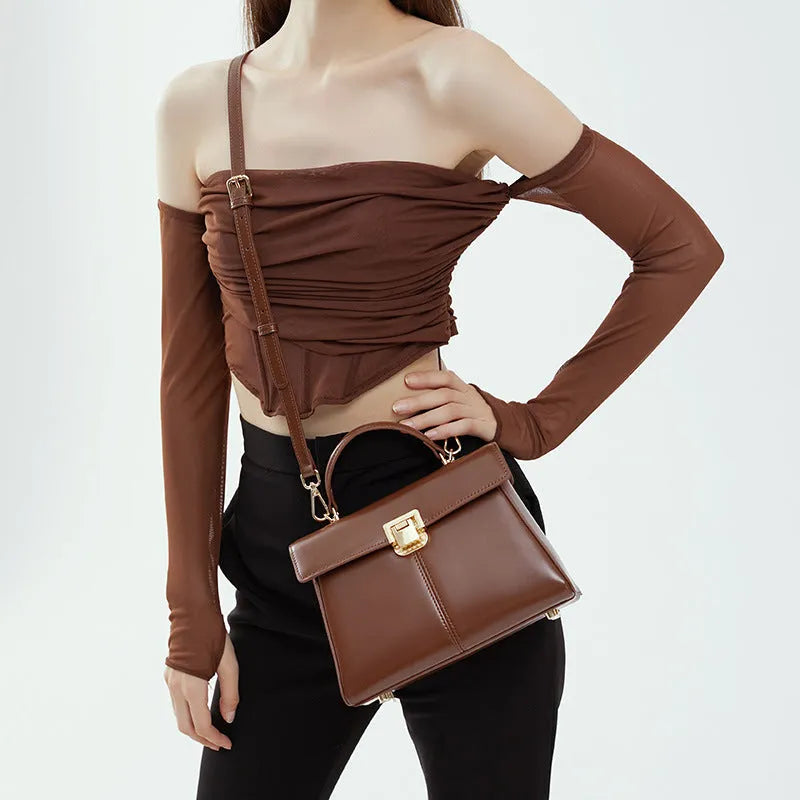 Black genuine leather women's shoulder bag with Vachette clasp closure and adjustable strap