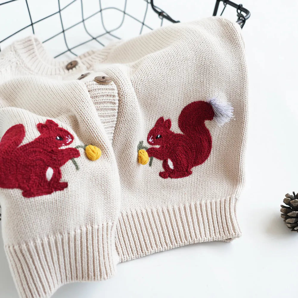 Kids cotton knit sweater with squirrel embroidery in beige colour on white background