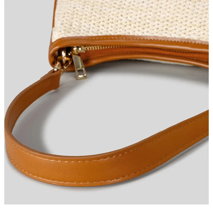 Khaki hand-woven straw crossbody bag with single shoulder strap showing textured PP grass construction